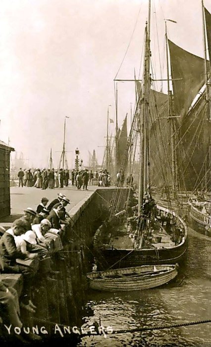 L63 Young Anglers at Lowestoft Harbour with Fishing Smacks moored-up behind and in the distance. 1900s 1910s..jpg